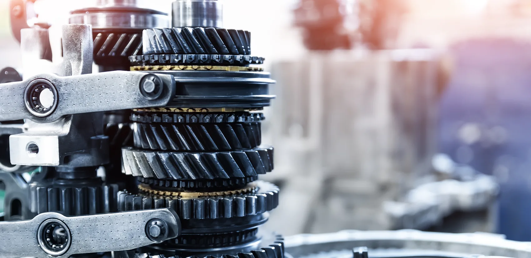 Gear train and synchronizer hubs of a car transmission on a workshop bench — reference photo